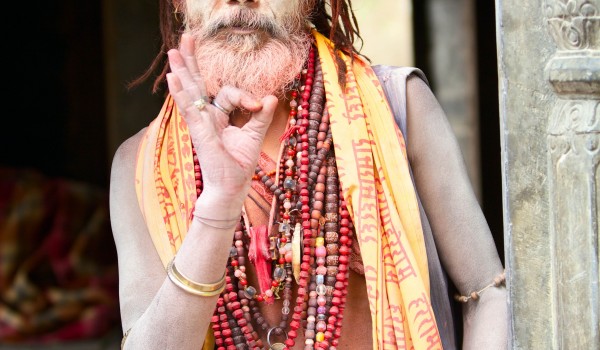 KATHMANDU, NEPAL - MAY 04: Holy Sadhu man with beard and traditional face paint sitting in Pashupatinath Temple on May 04, 2014 in Nepal, Kathmandu.