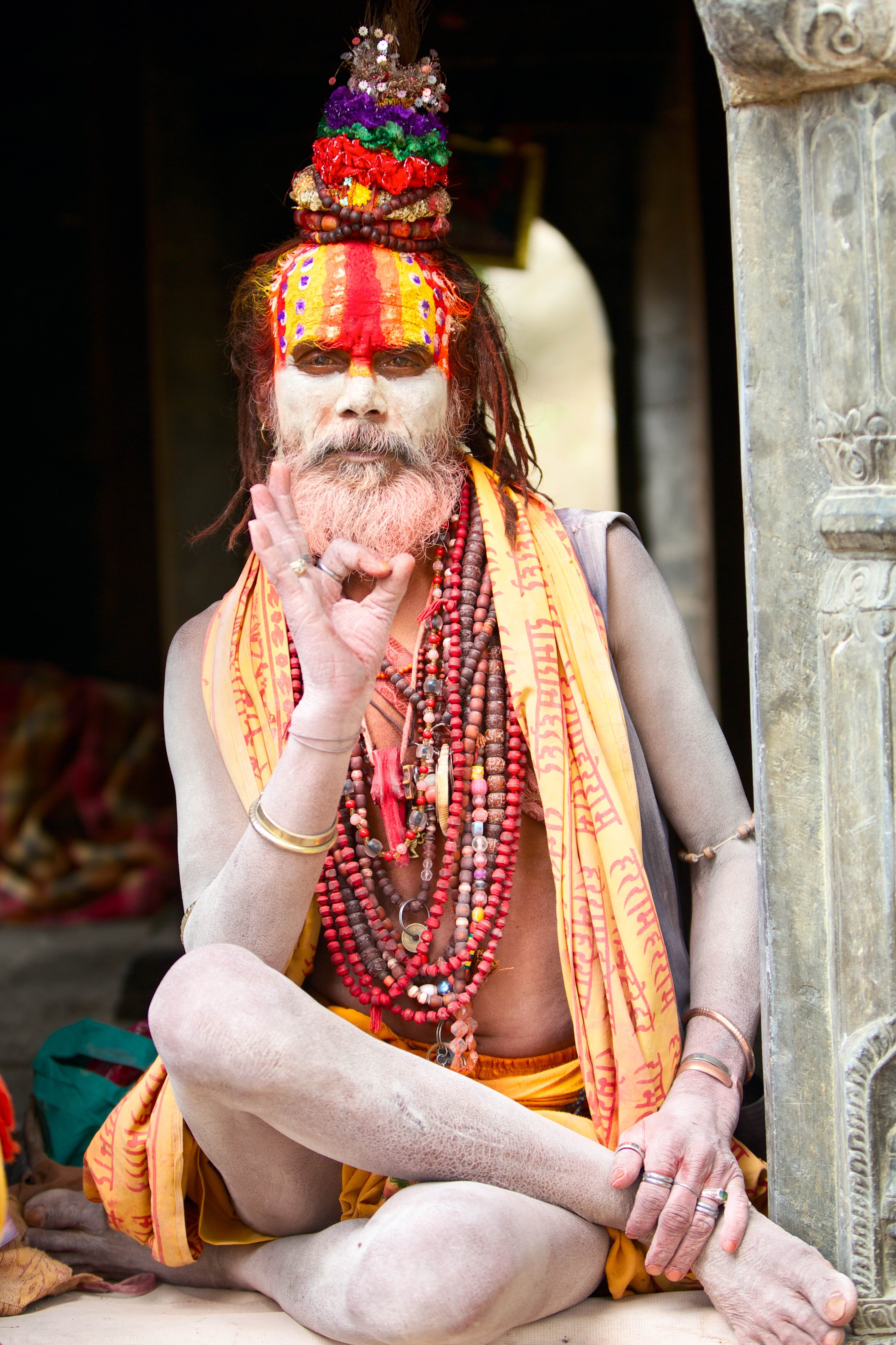 KATHMANDU, NEPAL - MAY 04: Holy Sadhu man with beard and traditional face paint sitting in Pashupatinath Temple on May 04, 2014 in Nepal, Kathmandu.